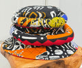 Stack of colorful patterned hats on a wooden block with a white background